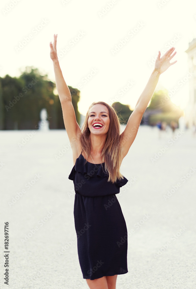 Happy young joyful carefree woman hands up in park Happy young joyful carefree woman hands up in park