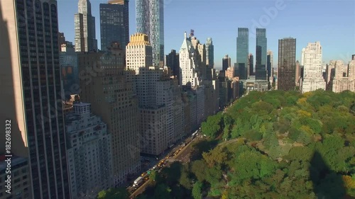 Aerial, camera is flying above Central Park, approaching to the corner of West 95th Street and Fifth Avenue