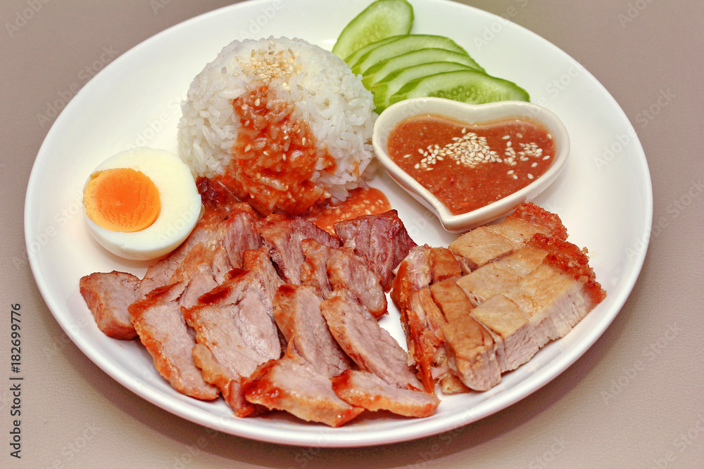 Jasmine rice with meat and boiled egg topped red sweet sauce . Jasmine rice with meat and boiled egg topped red sweet sauce .