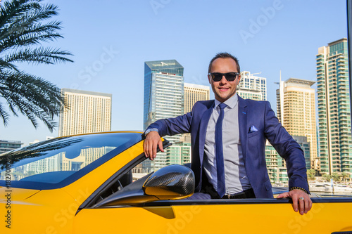 Photography Successful yang businessman in yellow cabrio car.