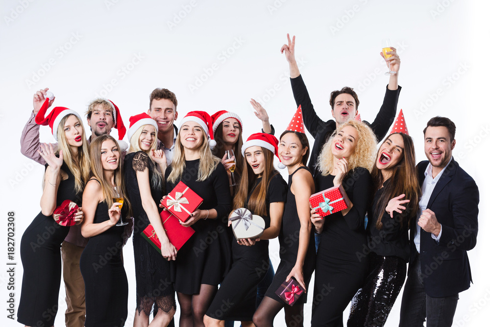 Happy young friends in black cloth standing over white background and having fun.