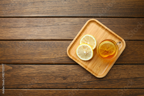 lemon black tea in glass cup on wooden table