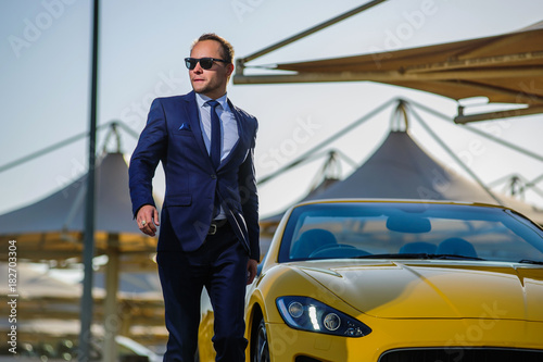 Successful yang businessman in yellow cabrio car in Dubai. photo