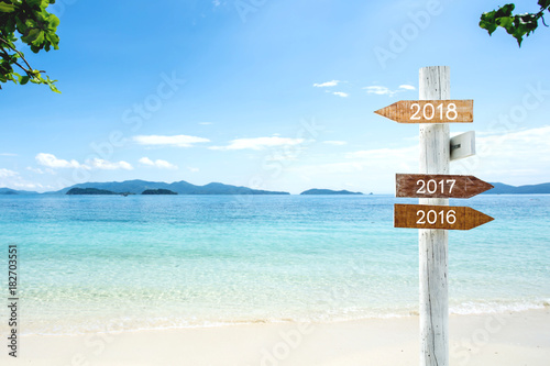 Wooden Sign with 2018, 2017, 2016 text for New year holiday decoration advertising.