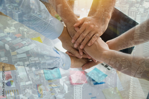 Parthnership and teamwork concept, Top view of  businessman take hand coordination over table or desk inclued paper graph and planning note  to get goals..mixed media photo