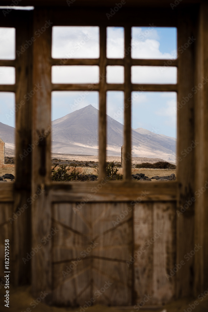 View of mountains in Jandia natural park through cementary gate, Fuerteventura, Canary Islands. Photo with shallow depth of field.