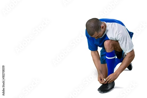 Football player tying his shoe lace