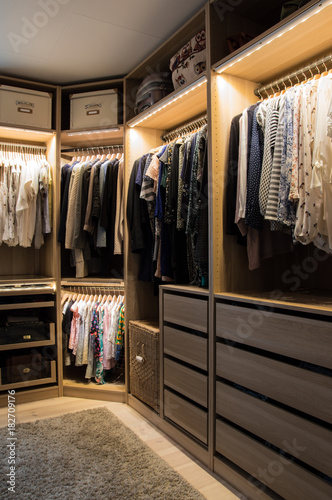 Luxurious walk in closet with lighting and jewelry display. photo
