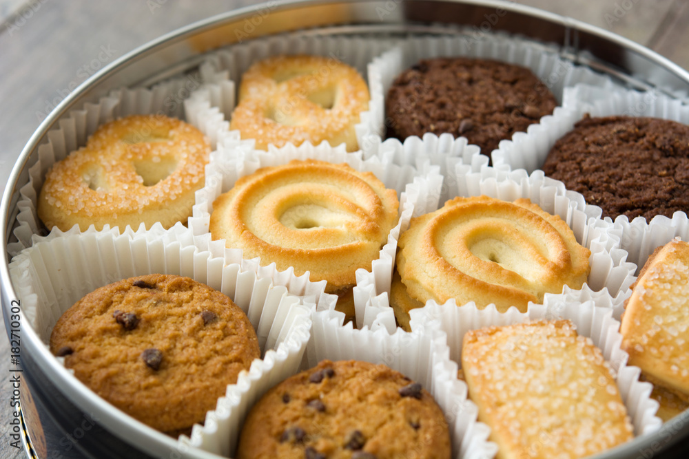 Assorted butter cookies in box on wooden table Assorted butter cookies in box on wooden table