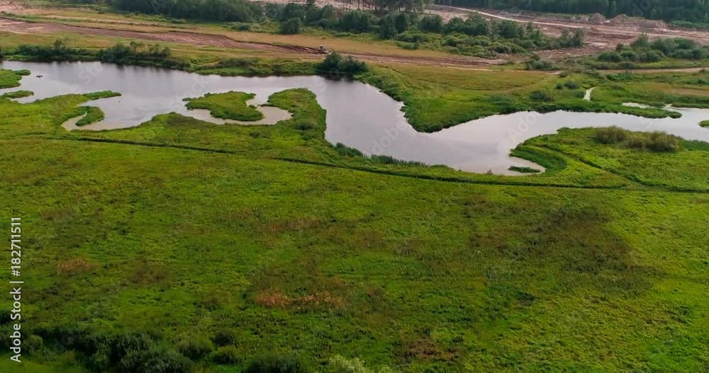 Bend of river aerial view from flying quadcopter over forest. Landscape panorama. Beautiful nature. Horizon in the background of fields of meadows and sky. Bend of river aerial view from flying quadcopter over forest. Landscape panorama. Beautiful nature. Horizon in the background of fields of meadows and sky.