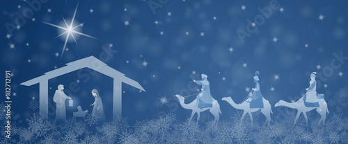 Christmas time. Nativity scene with Mary, Joseph, baby Jesus and three kings in Christmas landscape.