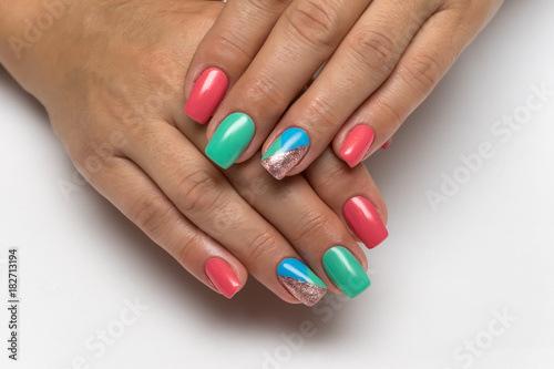 new year bright blue, pink, gold, green, mint manicure with triangles on long square nails on a white background

