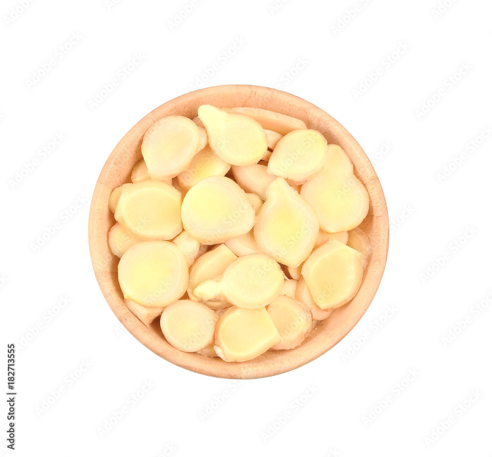 Fresh ginger with slices in the bowl wooden isolated on white background for herb and medical product concept, selective focus Fresh ginger with slices in the bowl wooden isolated on white background for herb and medical product concept, selective focus