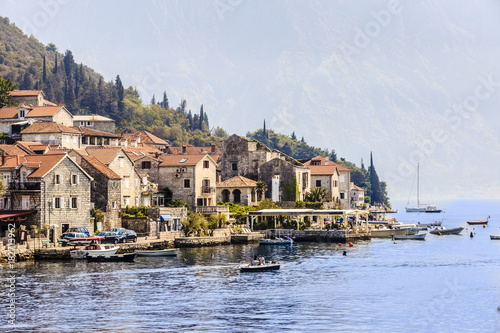 mountain architectural landscape on a summer day Montenegro  a small village by the sea on a background of mountains