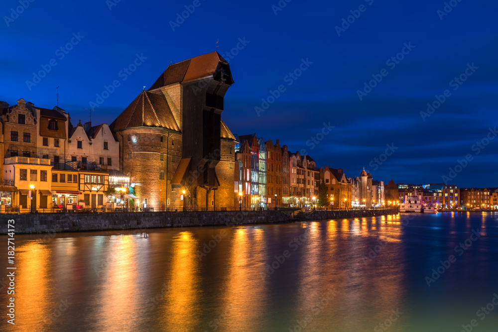 Famous old port crane of Gdansk and Motlawa river at night.  Poland, Europe.