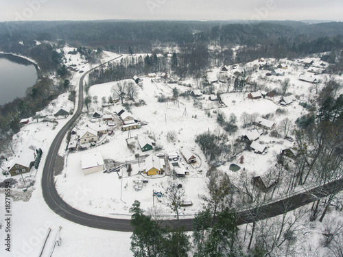 Aerial view over small village Liskiava, Lithuania. Winter season with cloudy sky. photo