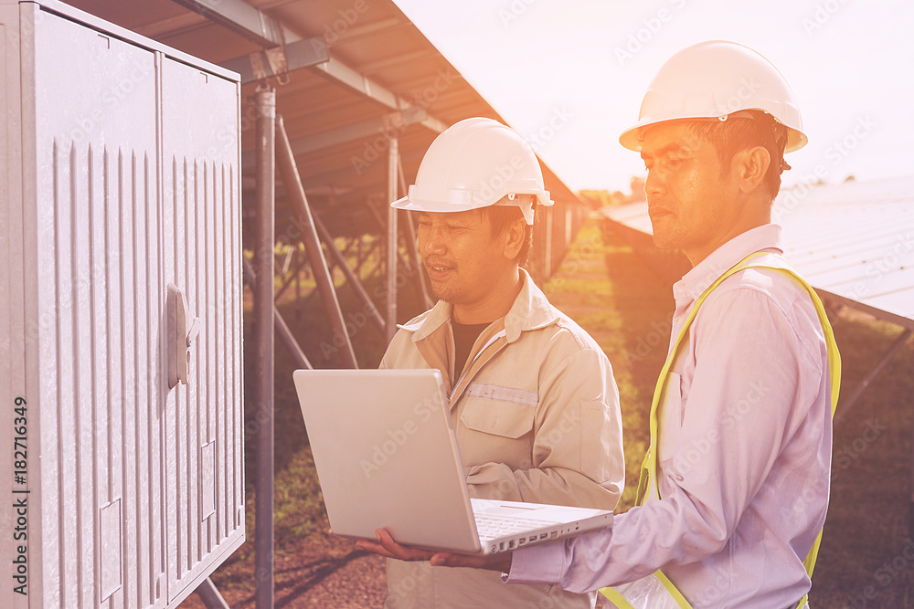 engineer working on checking and maintenance electrical equipment ; engineer inspector working on examining electrical system of solar power plant engineer working on checking and maintenance electrical equipment ; engineer inspector working on examining electrical system of solar power plant