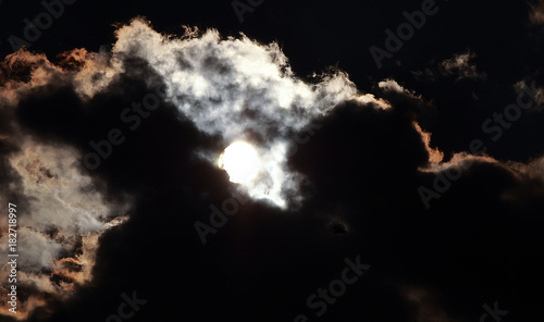 moon coming out from behind clouds