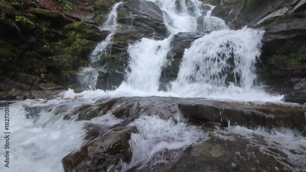 Powerful stream of Whimper Waterfall in Carpathians (Ukraine) with low angle above the water (1080p, 25fps, sound) Powerful stream of Whimper Waterfall in Carpathians (Ukraine) with low angle above the water (1080p, 25fps, sound)