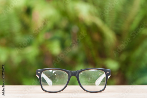 Old eyeglasses on wooden table.