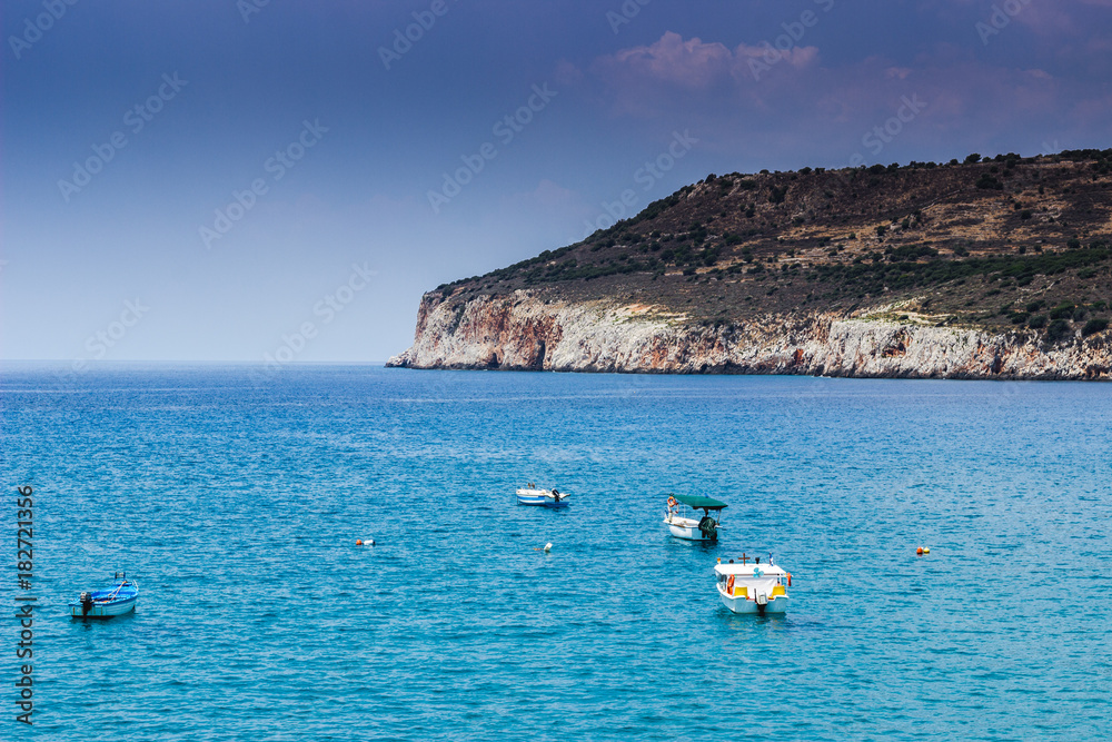 Boats in the ocean overlooking a mountain in Greece