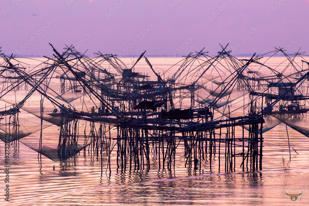 
sunshine above  fishing trap at Pak Pra in Talay Noi Phaphalung.in the morning during the sunrise fisherman prepare fishing trap in the sea at Pak Pra canal