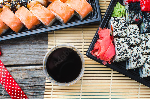 Sushi in a black container on a wooden table colorful and beautiful photo