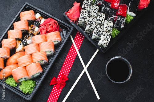 Sushi in a black container on a wooden table colorful and beautiful photo