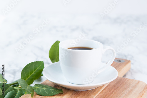 cup of coffee on a marble background with a wooden board