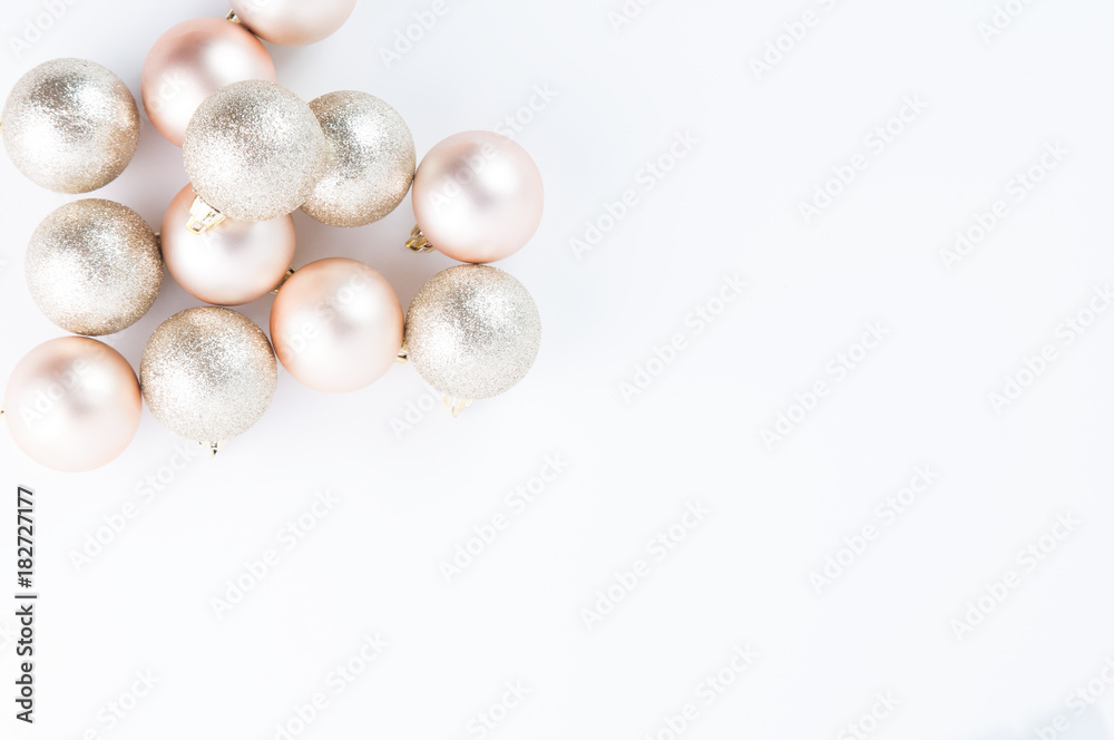 Rose gold Christmas decorations on a white background