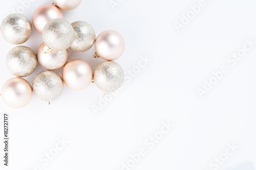 Rose gold Christmas decorations on a white background