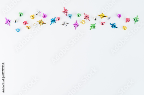 little colorful christmas ornaments on a white background with lots of copyspace