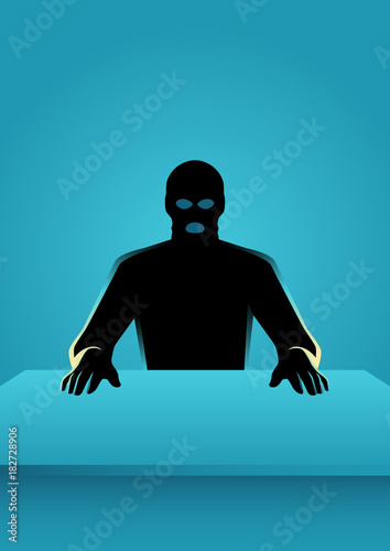 Man in mask sitting in front of a table