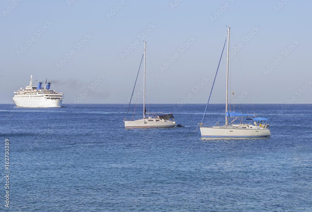 Three boats on the blue clean natural sea for transportation or vacation