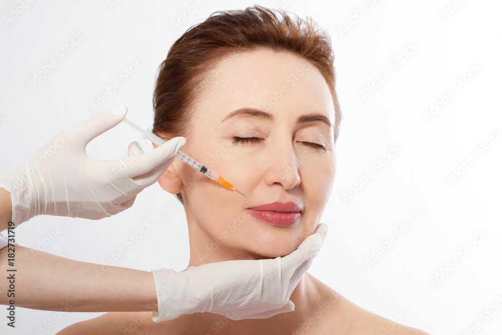 Close up doctor hands making lifting injection. Macro Woman Face isolated. Anti aging Concept. Mock up and copy space