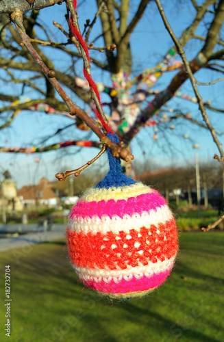 close up of multicoloured bauble in yarn bomb event