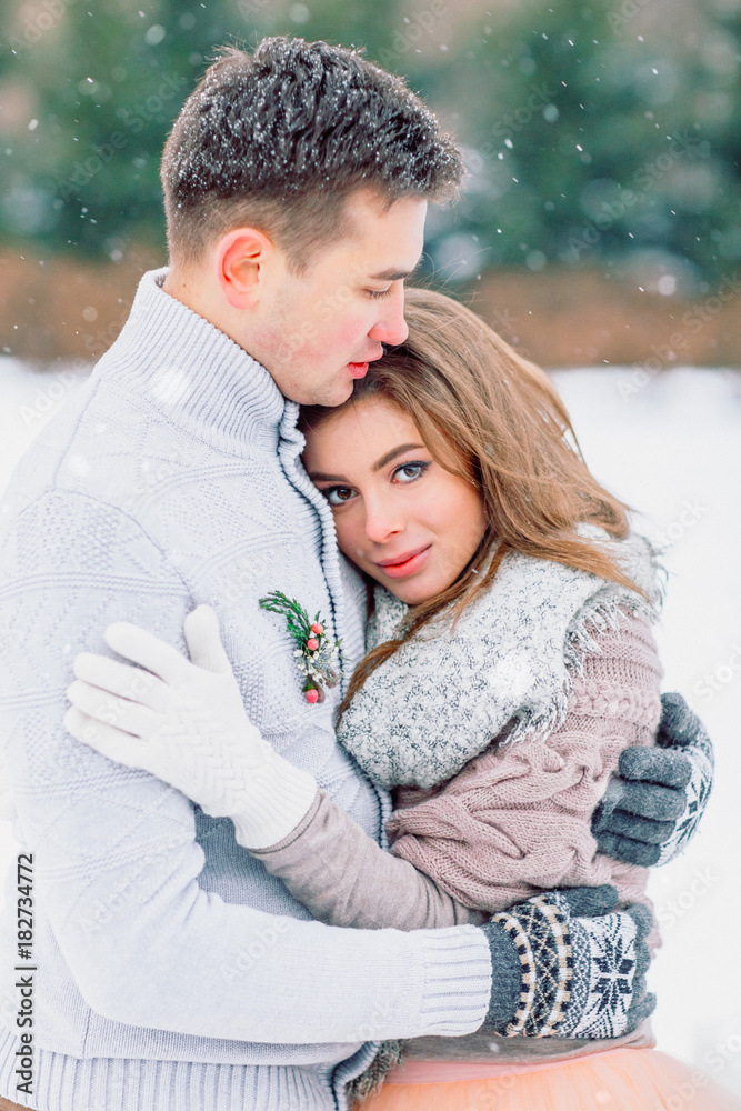 Fototapeta premium Groom hugging beautiful bride. Winter wedding.