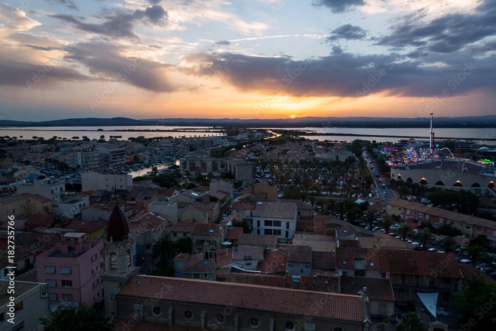 Sunset with last sunbeam on French city of Palavas-les-Flots, view on the city underneath.