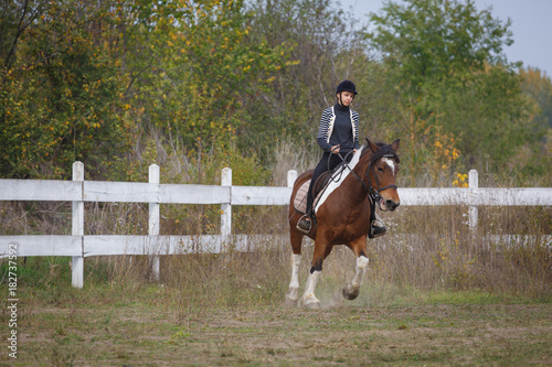 Girl riding horse outdoor