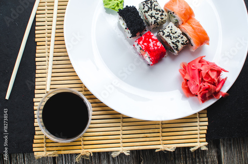 on the plate is white, lined with different rolls, sushi photo