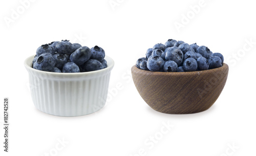 Blueberries in bowl isolated on white background. Berries at border of image and blueberries in bowls. Background berries.