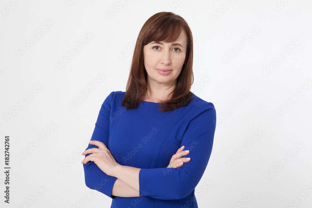 Portrait of brunette serious woman in blank white t-shirt. Crossed arms on chest. Copy space on white background. Mock up and mother day Portrait of brunette serious woman in blank white t-shirt. Crossed arms on chest. Copy space on white background. Mock up and mother day