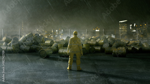 Arbeiter steht vor Fässern mit Atommüll photo