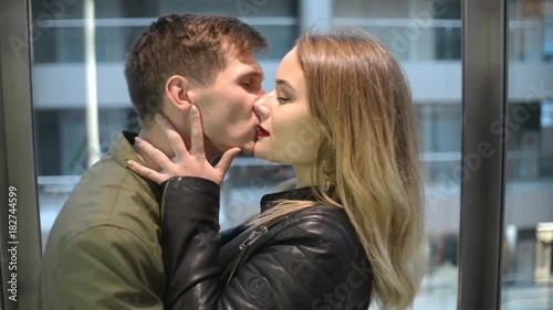 Young Man and Woman romantic kissing in an Elevator