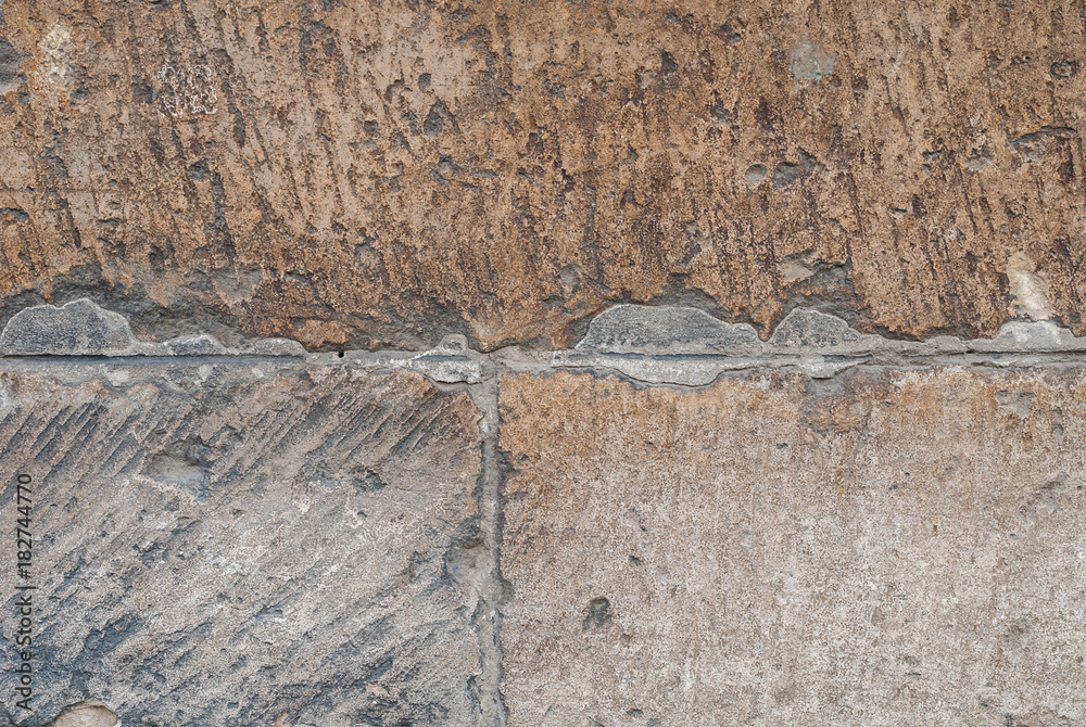 Fototapeta premium cracks in old stone blocks, chipped paint, beige texture, background