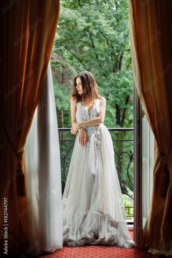 Fototapeta premium bride stands near the window