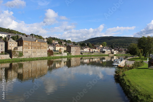 French city with river and old buildings