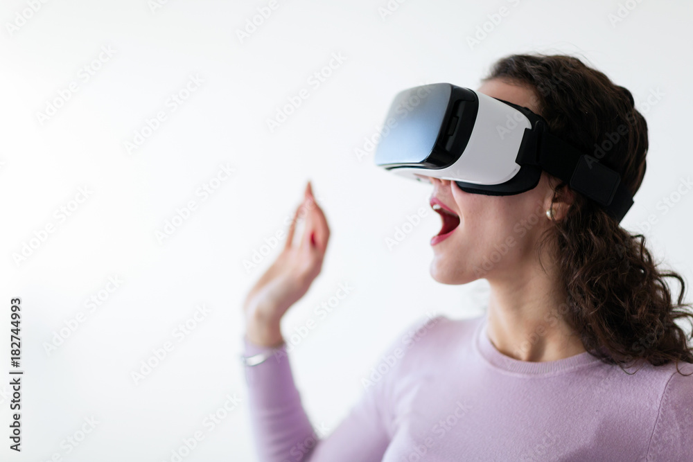 Young excited woman trying virtual reality headset Young excited woman trying virtual reality headset