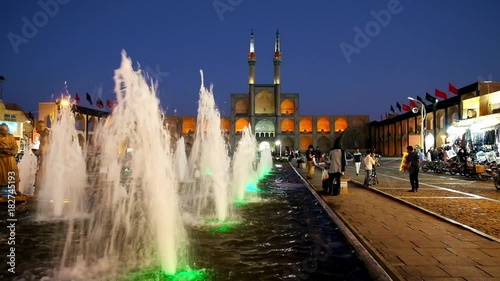 The view on bronze sculptures of water carriers with Amir Chakhmaq complex on the background, Yazd photo