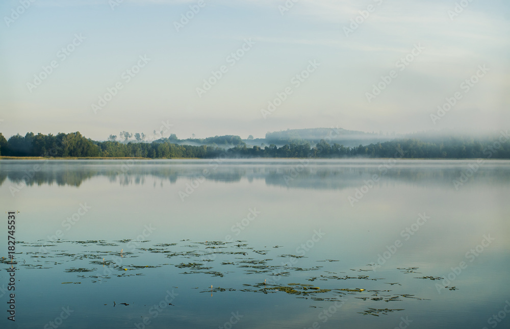 Calm lake foggy morning